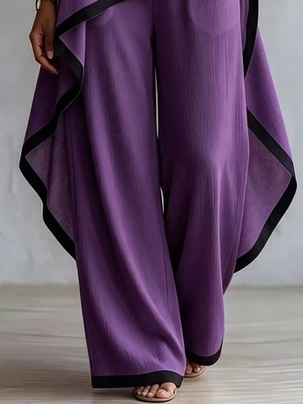 Plus size high-low top and pants set with contrast trim, trendy fashion by Trendsi, featuring a stylish coordinated ensemble.