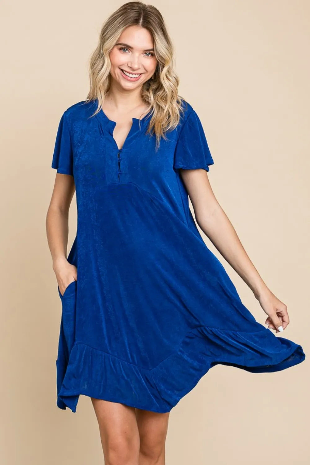 Trendsi Culture Code short sleeve ruffled asymmetric hem dress displayed on a hanger, showcasing its stylish design and fabric details.