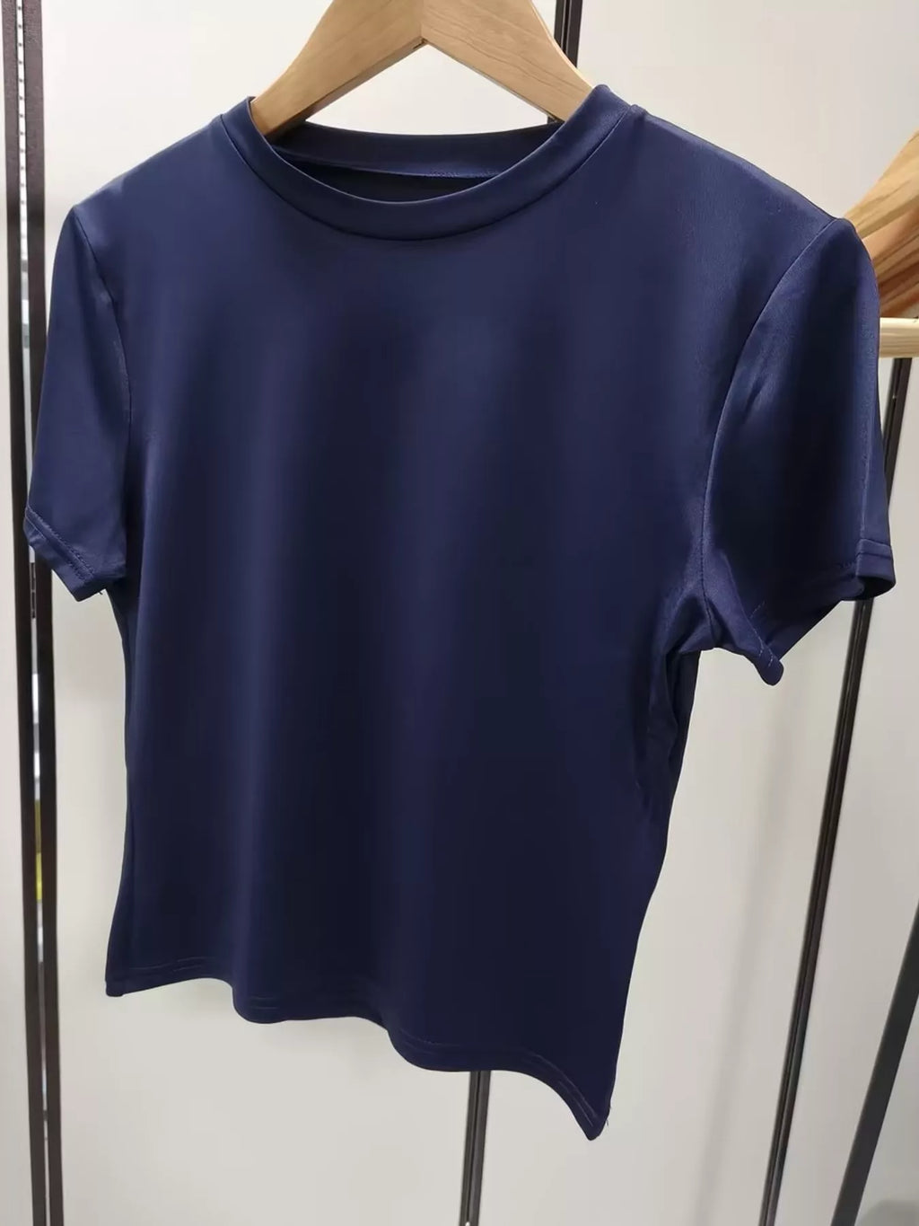 Slim fit basic crew neck short sleeve crop T-shirt by Trendsi, shown in black with a fitted silhouette and classic crew neckline.