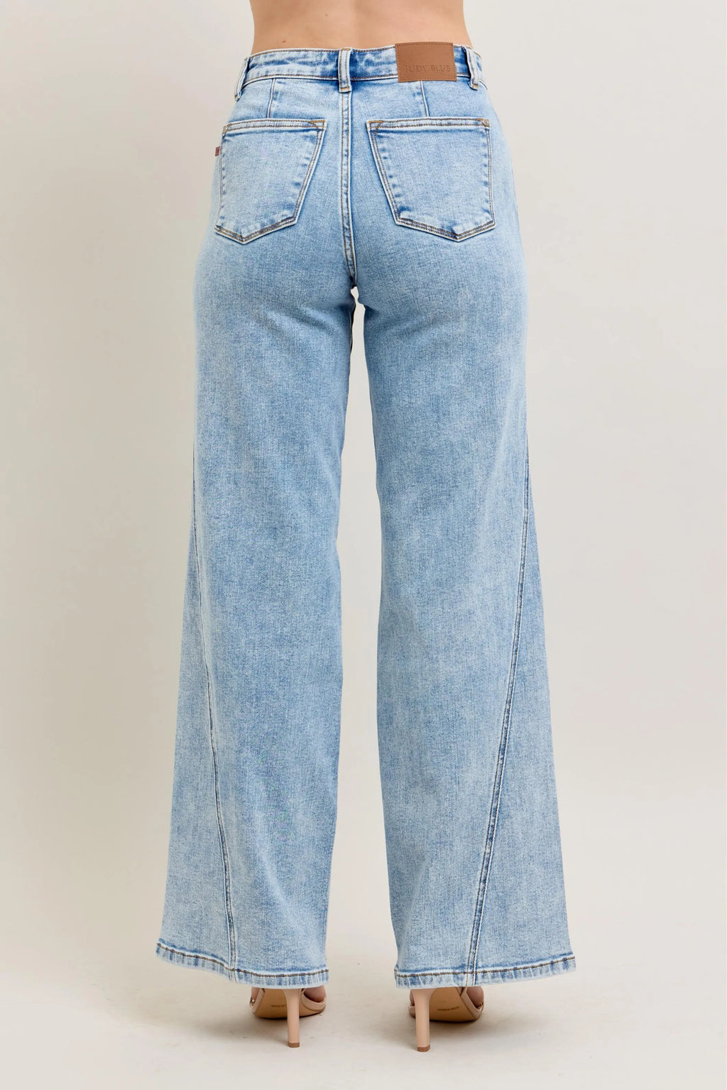Plus size Judy Blue high waist wide-leg jeans with skewed inseam, showcasing a relaxed fit and trendy denim style.