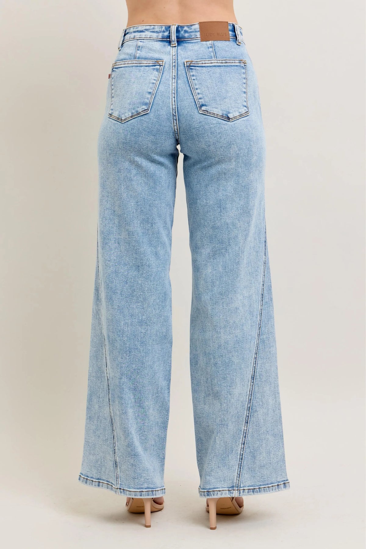Plus size Judy Blue high waist wide-leg jeans with skewed inseam, showcasing a relaxed fit and trendy denim style.