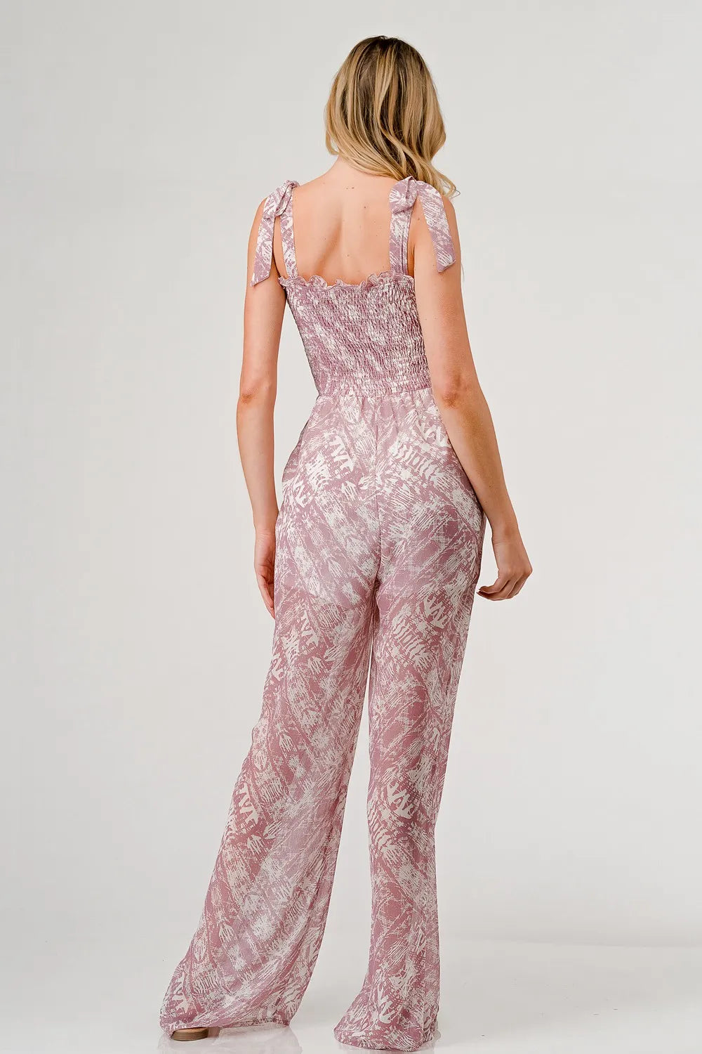 Printed GeeGee tie-shoulder wide-leg jumpsuit by Trendsi, shown in a full-length view with stylish design and relaxed fit.
