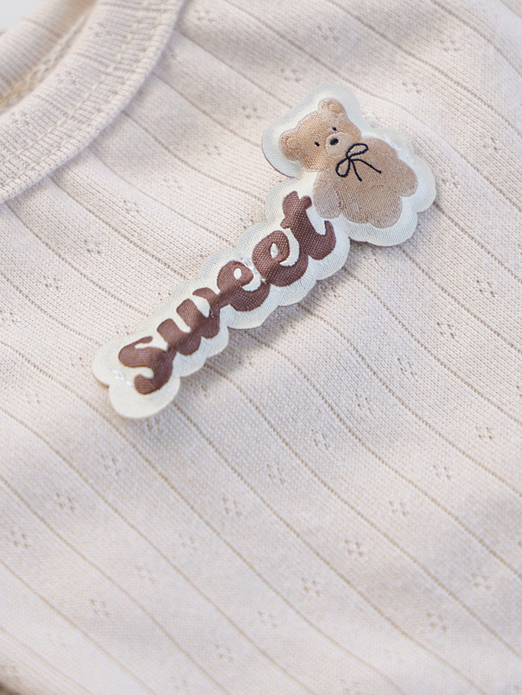 Ribbed pet top with sweet bear patch, stylish and cozy, designed by Trendsi for comfortable pet wear.