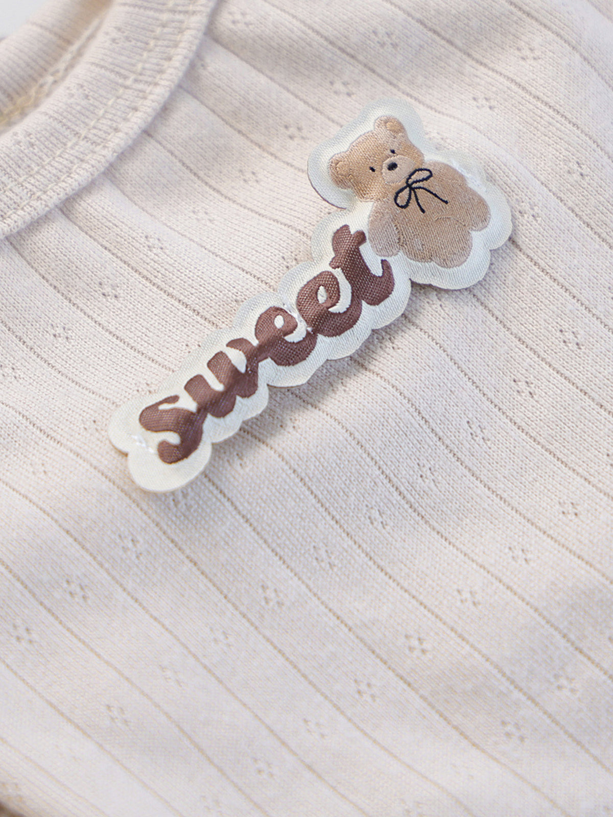 Ribbed pet top with sweet bear patch, stylish and cozy, designed by Trendsi for comfortable pet wear.