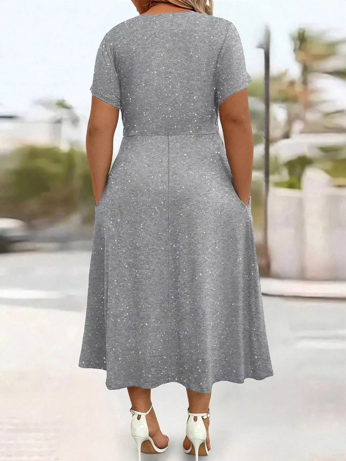 Plus size twisted front short sleeve midi dress with pockets by Trendsi, featuring a full-length design and stylish front twist detail.