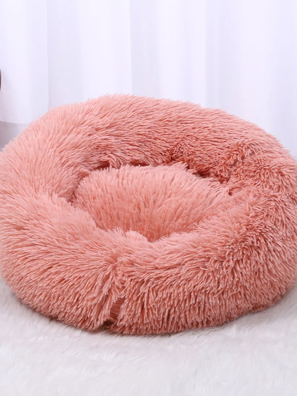 Soft, fluffy plush donut-shaped pet nest in pastel colors, designed by Trendsi for cozy comfort for small pets.