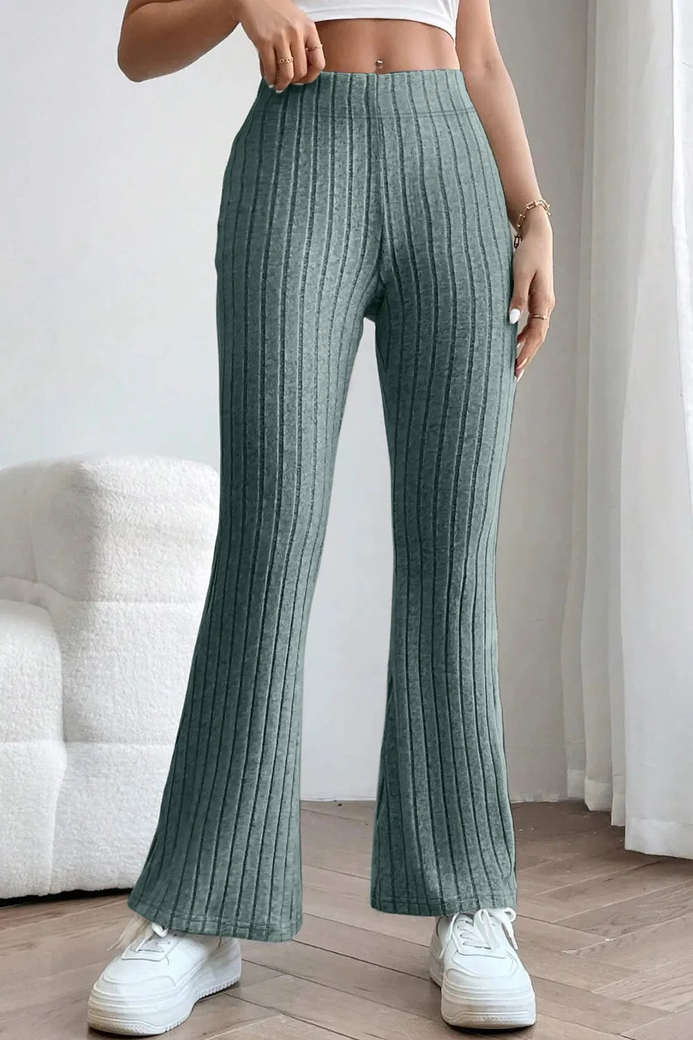 Ribbed high waist flare pants in basic Bae style, black color, made by Trendsi, with a fitted waistband and wide leg design