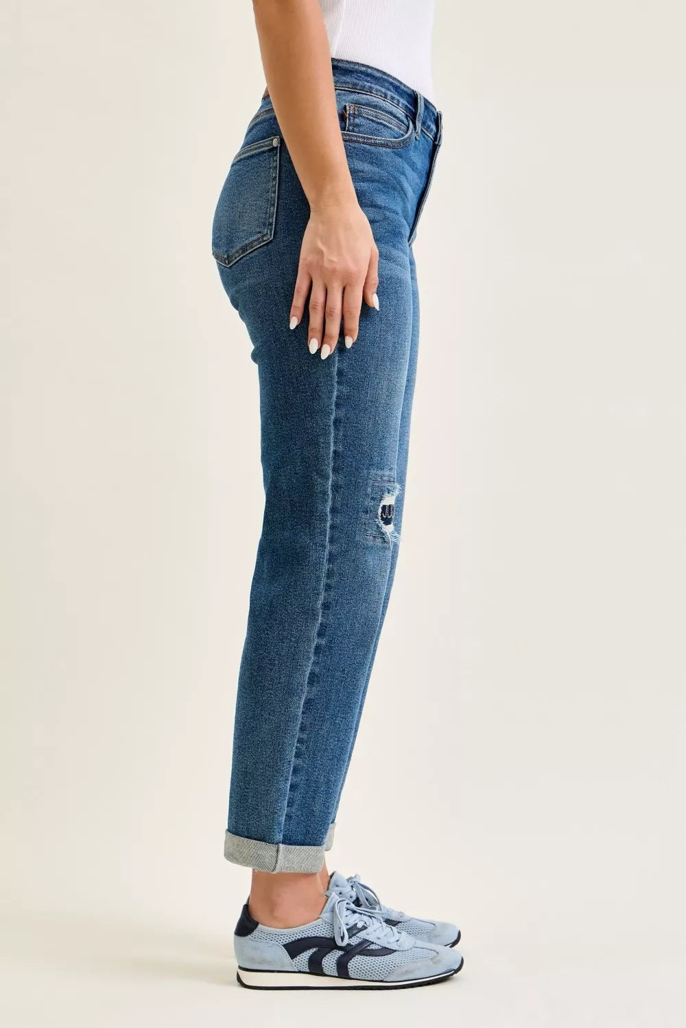 Light blue Judy Blue mid-rise boyfriend jeans with embroidered repair patches and relaxed fit, showcasing trendy denim style.