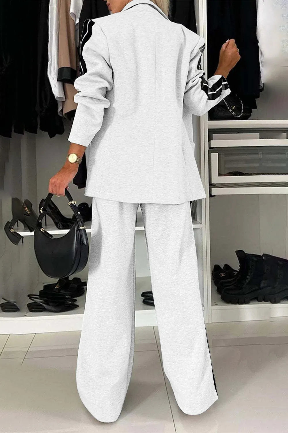 Full size contrast lapel collar top and pants set by Trendsi, featuring a stylish coordinated outfit with a lapel collar design.