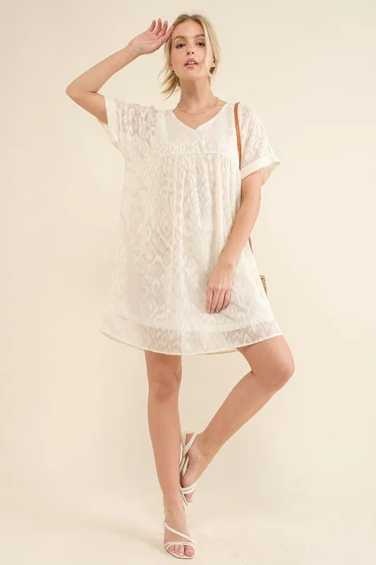 White woven leopard baby doll dress by Trendsi featuring roll-sleeves and a casual, relaxed fit for stylish everyday wear.