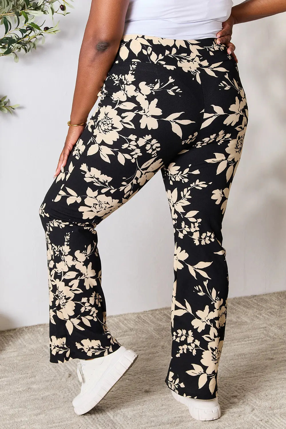 Plus size Heimish high waist floral flare pants in vibrant floral print, styled for a trendy, comfortable look.