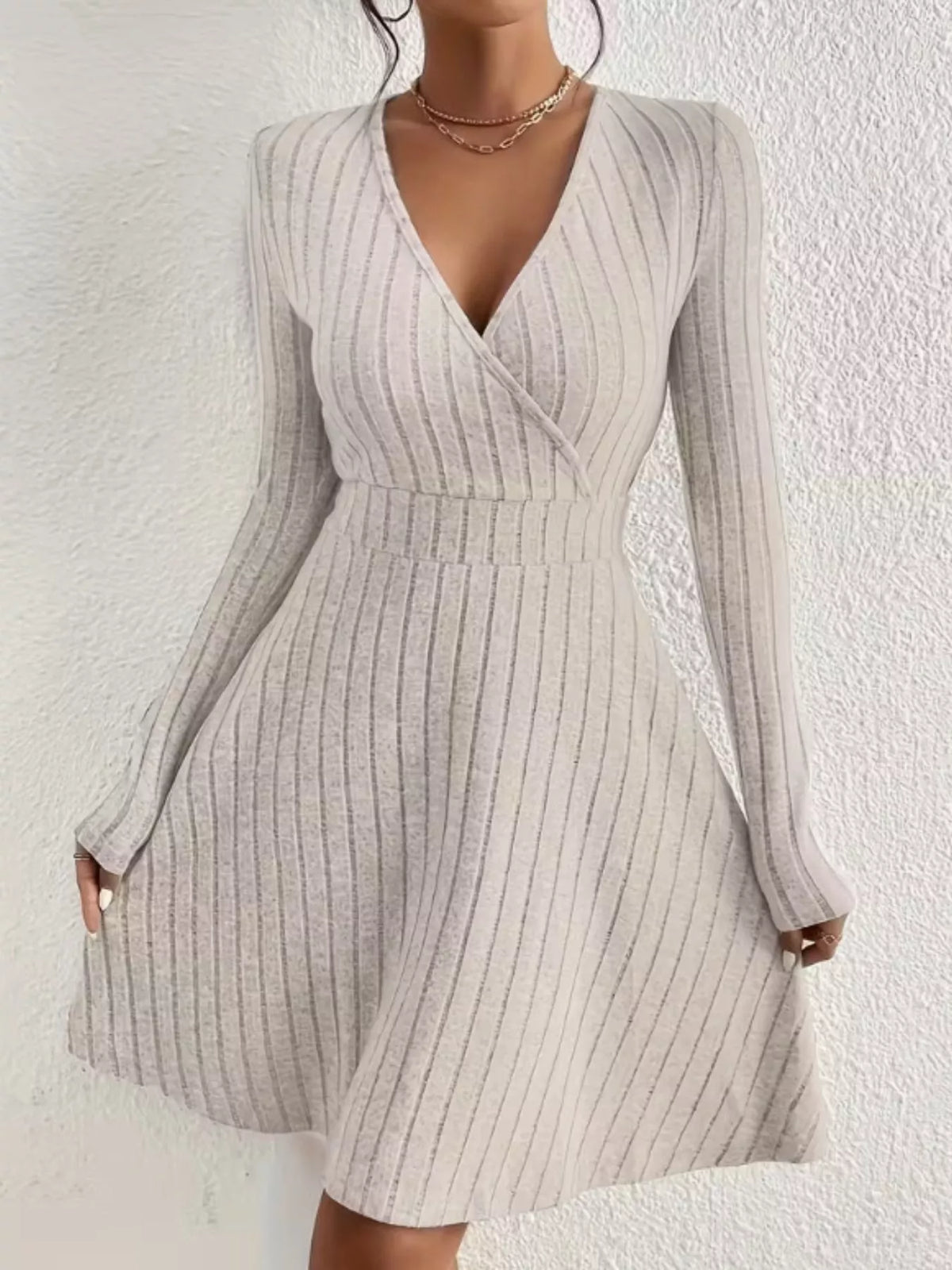 Ribbed knit wrap mini dress in neutral color featuring long sleeves and a fitted silhouette, designed by Trendsi.
