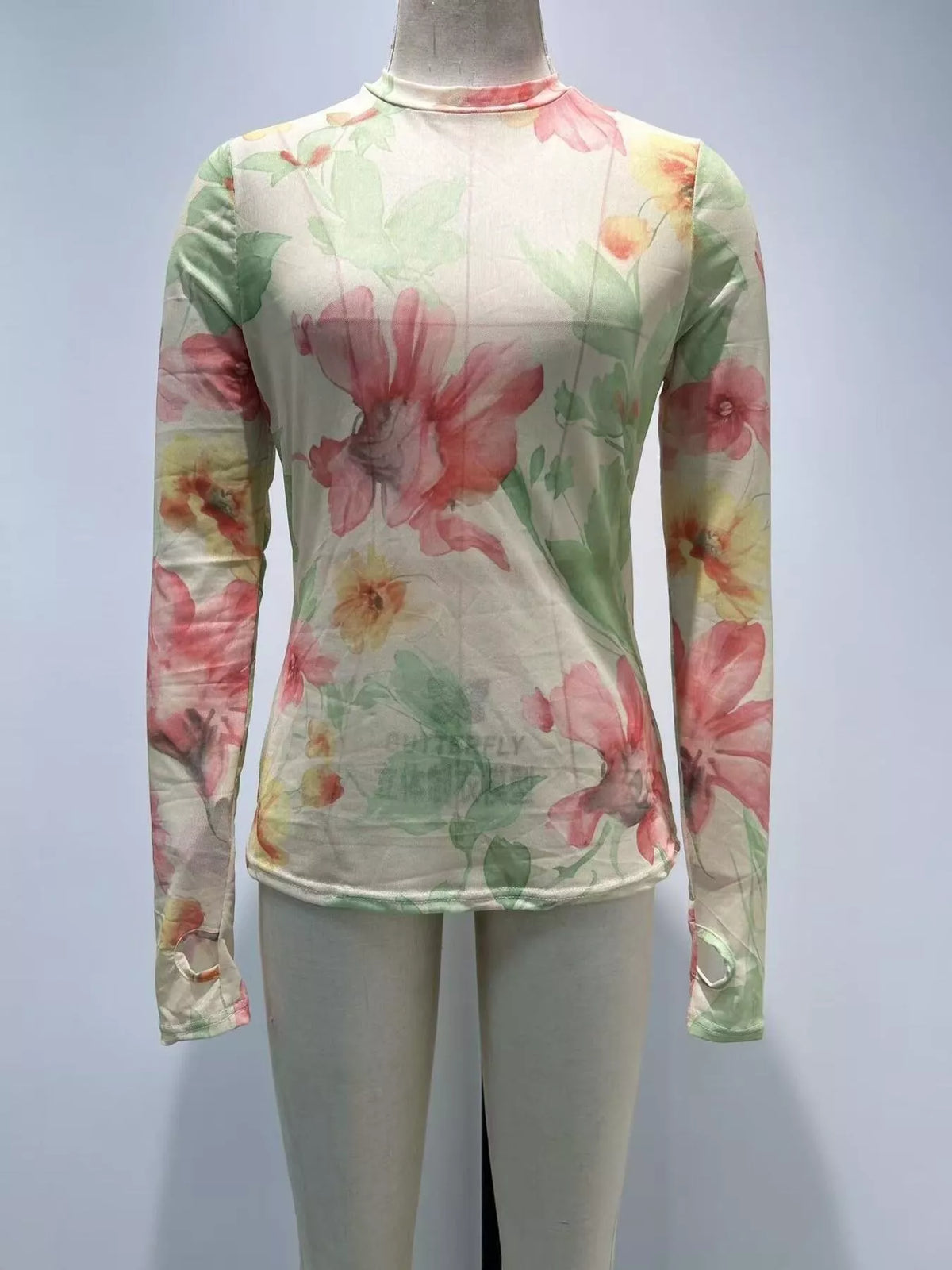 Plus size floral print sheer mesh long sleeve T-shirt by Trendsi, featuring a lightweight, see-through fabric with vibrant floral design.
