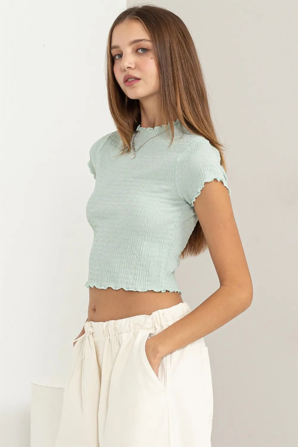Trendy HYFVE lettuce hem crop top in soft fabric, featuring a stylish lettuce-edged hem and casual fit.