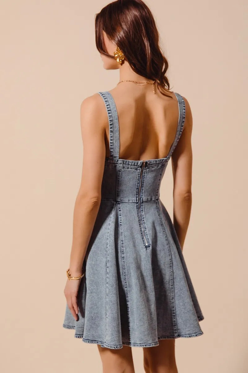 Mineral washed bow ribbon denim flare dress from Trendsi featuring a fitted bodice and flowy skirt with bow accents.