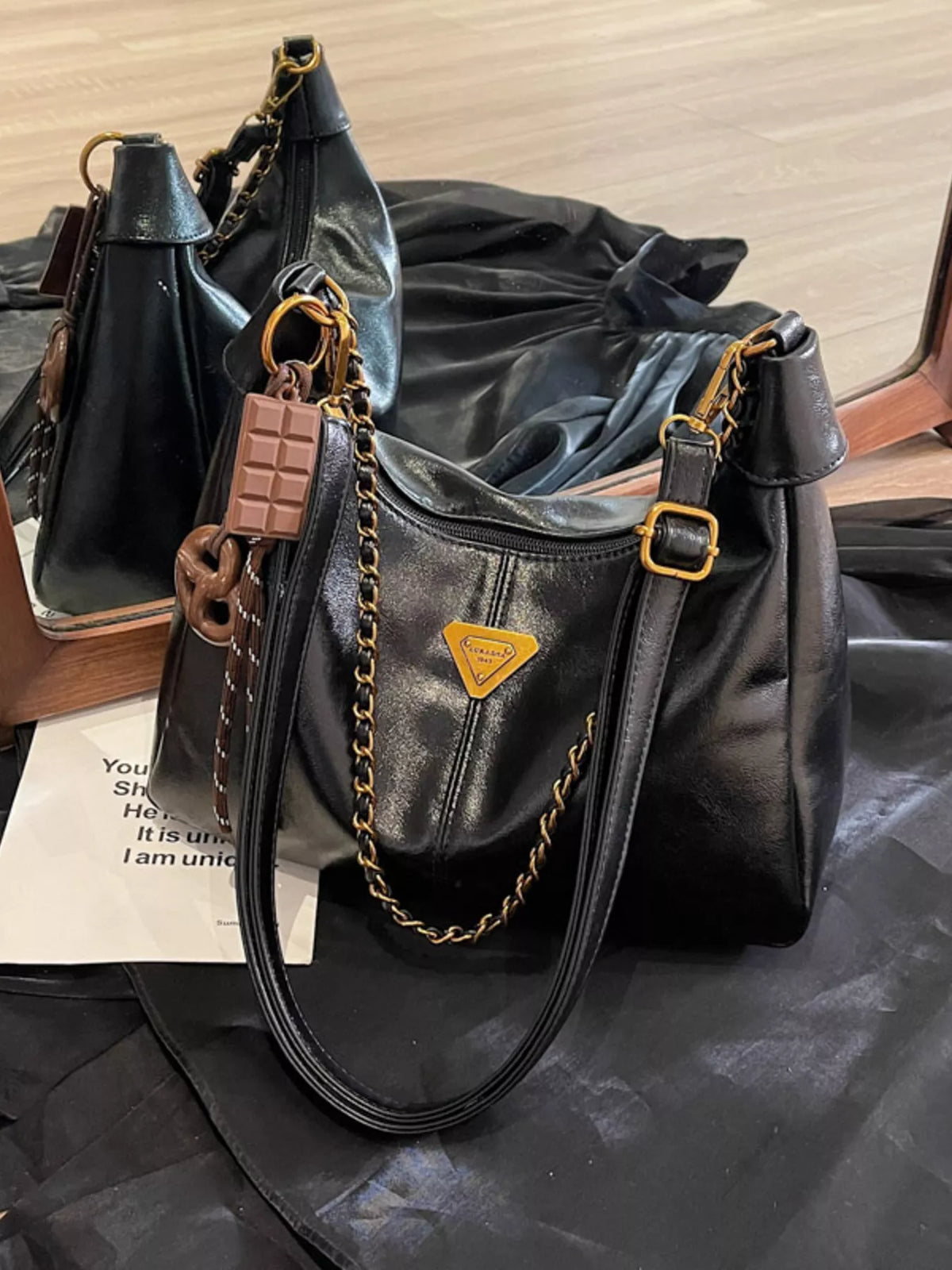 Trendsi chain detail crossbody bag with sleek design and adjustable strap, featuring a stylish chain accent on the front.