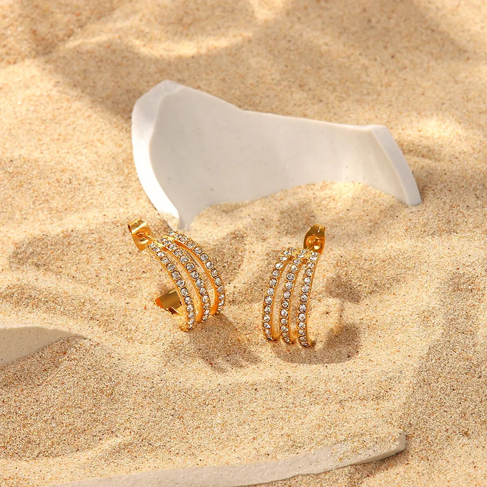 Stainless steel C-hoop earrings with inlaid zircon stones, featuring a sleek and shiny jewelry design.