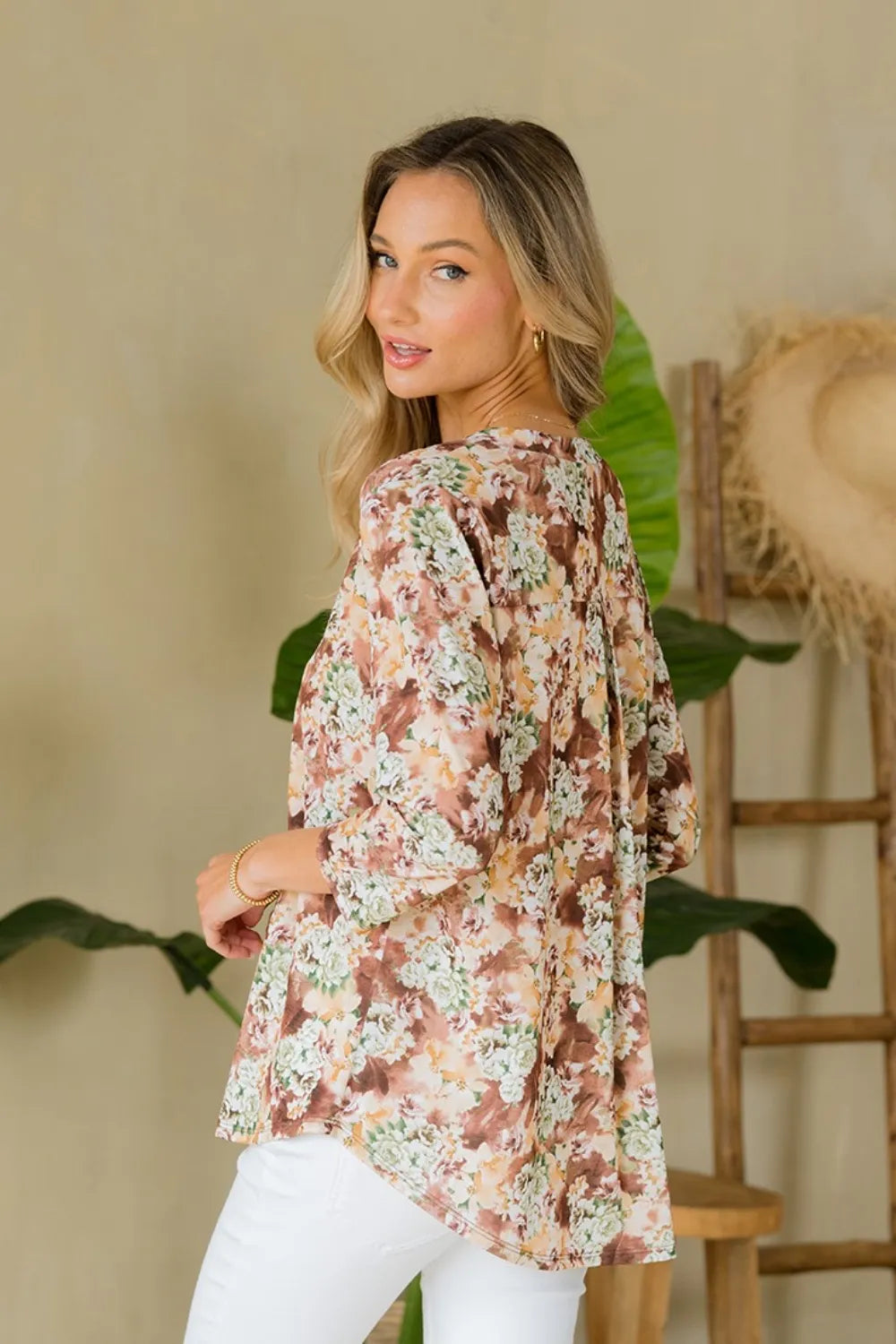 Full size Sew In Love floral notched top by Trendsi, showing its wrinkle-free fabric and vibrant floral pattern on a women's blouse.