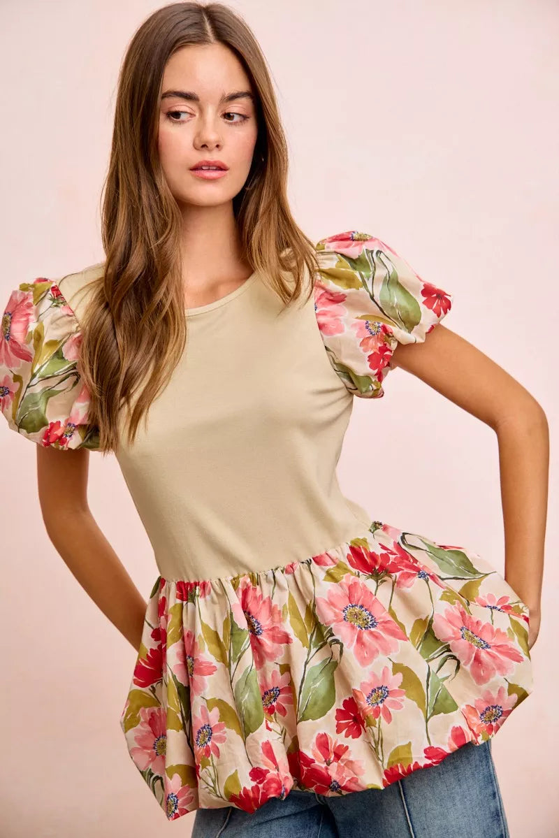 Floral printed bubble sleeve and peplum hem top by Trendsi, featuring a stylish design with vibrant floral patterns and ruffled details.