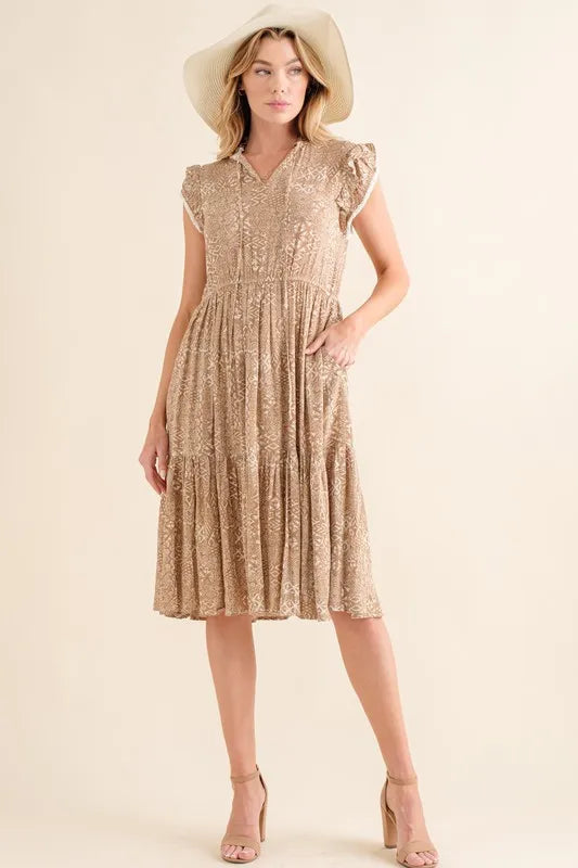 Boho printed tiered maxi dress from And The Why by Trendsi, featuring colorful patterns and flowing fabric.