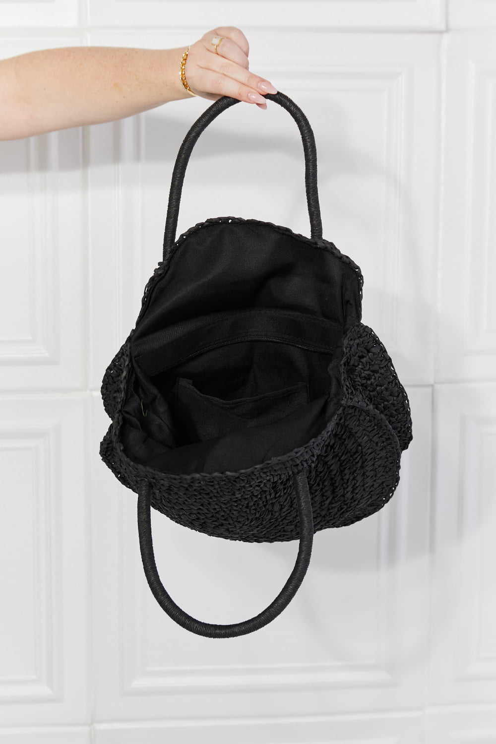 Justin Taylor Beach Date straw rattan handbag in black with woven design and rounded shape, perfect for summer outings.