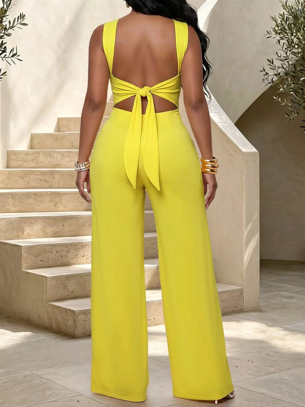 Backless twist top and wide-leg pants set by Trendsi, featuring a stylish backless design and comfortable flowy pants.