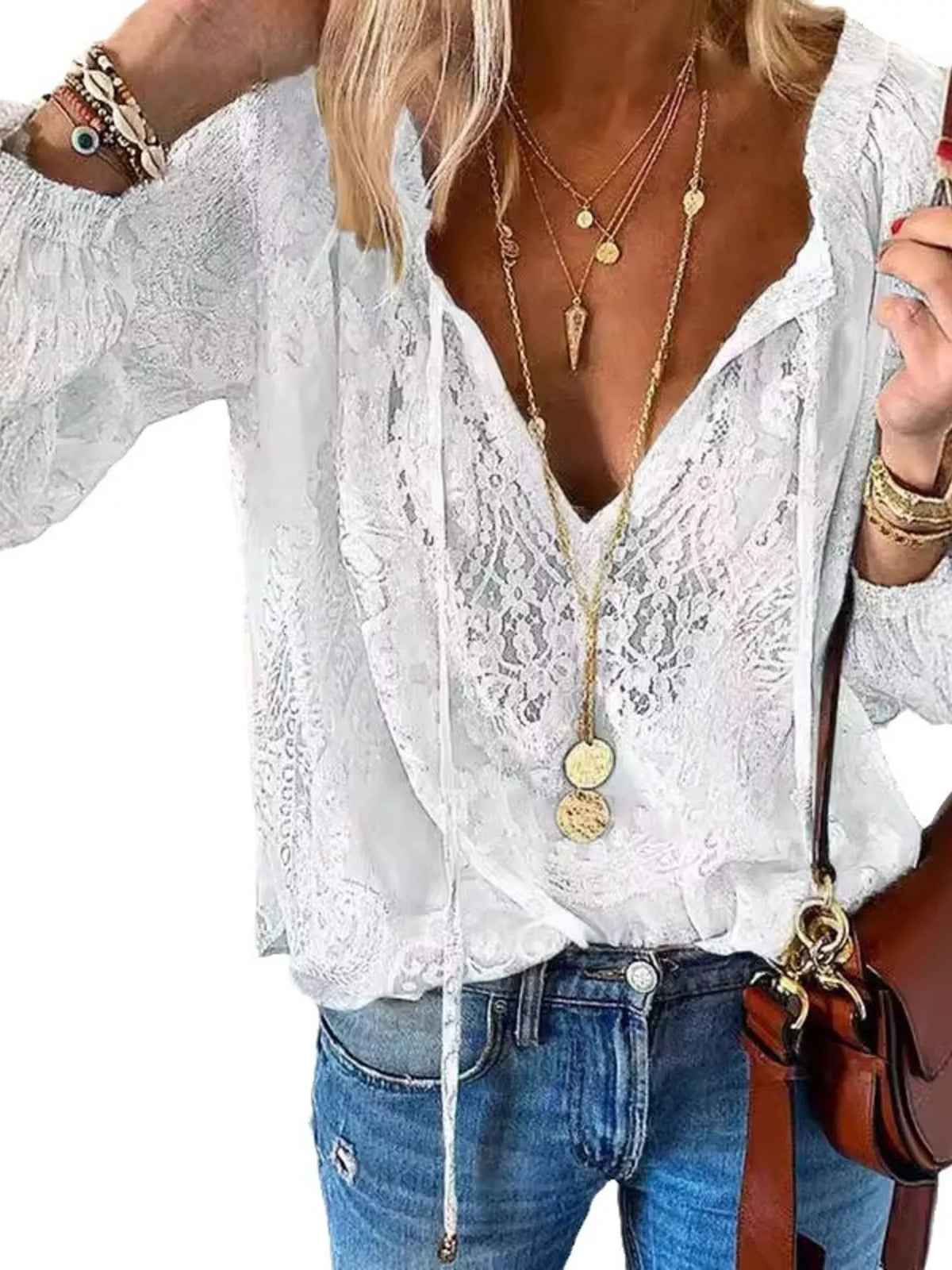 Lace tie-neck blouse by Trendsi featuring delicate lace details and a stylish tie at the neckline, displayed on a hanger.