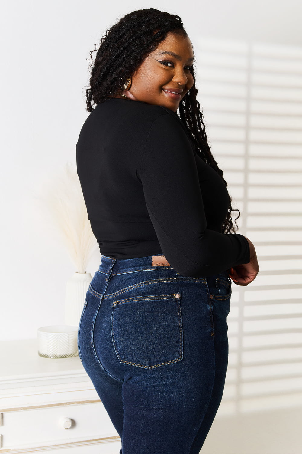 Basic Bae asymmetrical neck long sleeve top by Trendsi, shown in black with a stylish asymmetric neckline and fitted long sleeves.