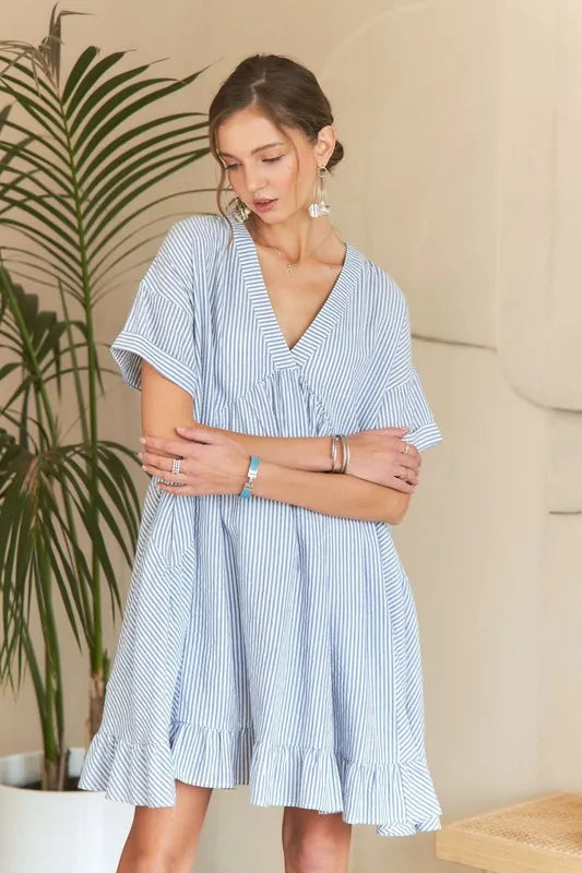 Striped ADORA Ruffled Hem V-Neck Babydoll Dress by Trendsi featuring a flowy silhouette and ruffled hem detail.
