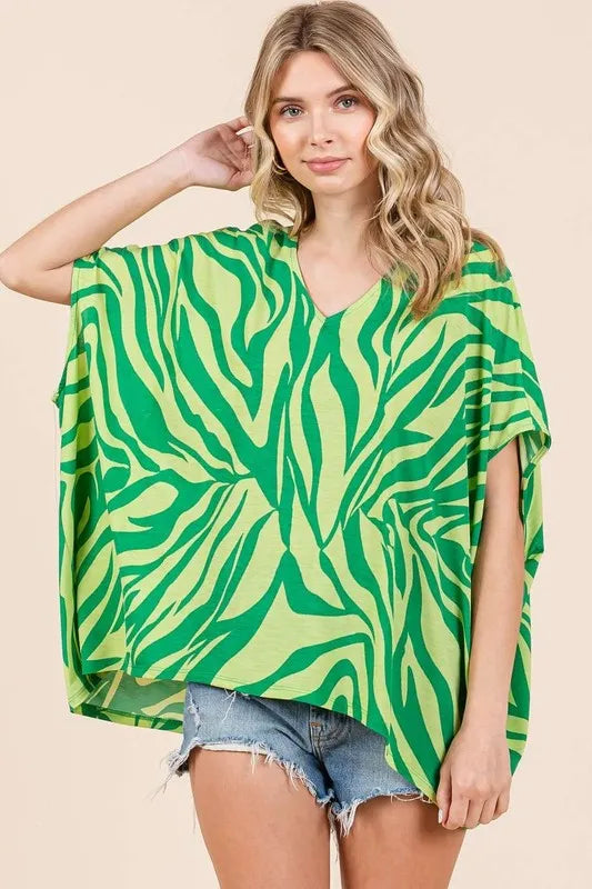 Zebra print V-neck short sleeve oversized top by Trendsi, stylish and comfortable women's fashion top with bold black and white pattern.