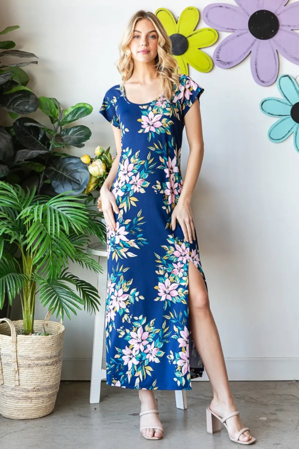 Heimish full-size floral short sleeve slit dress with a vibrant pattern, perfect for casual or summer wear.