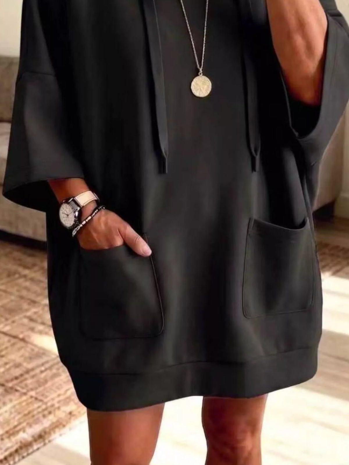 Plus size oversized hoodie with front pockets and drawstring, featuring a relaxed fit and casual style from Trendsi.