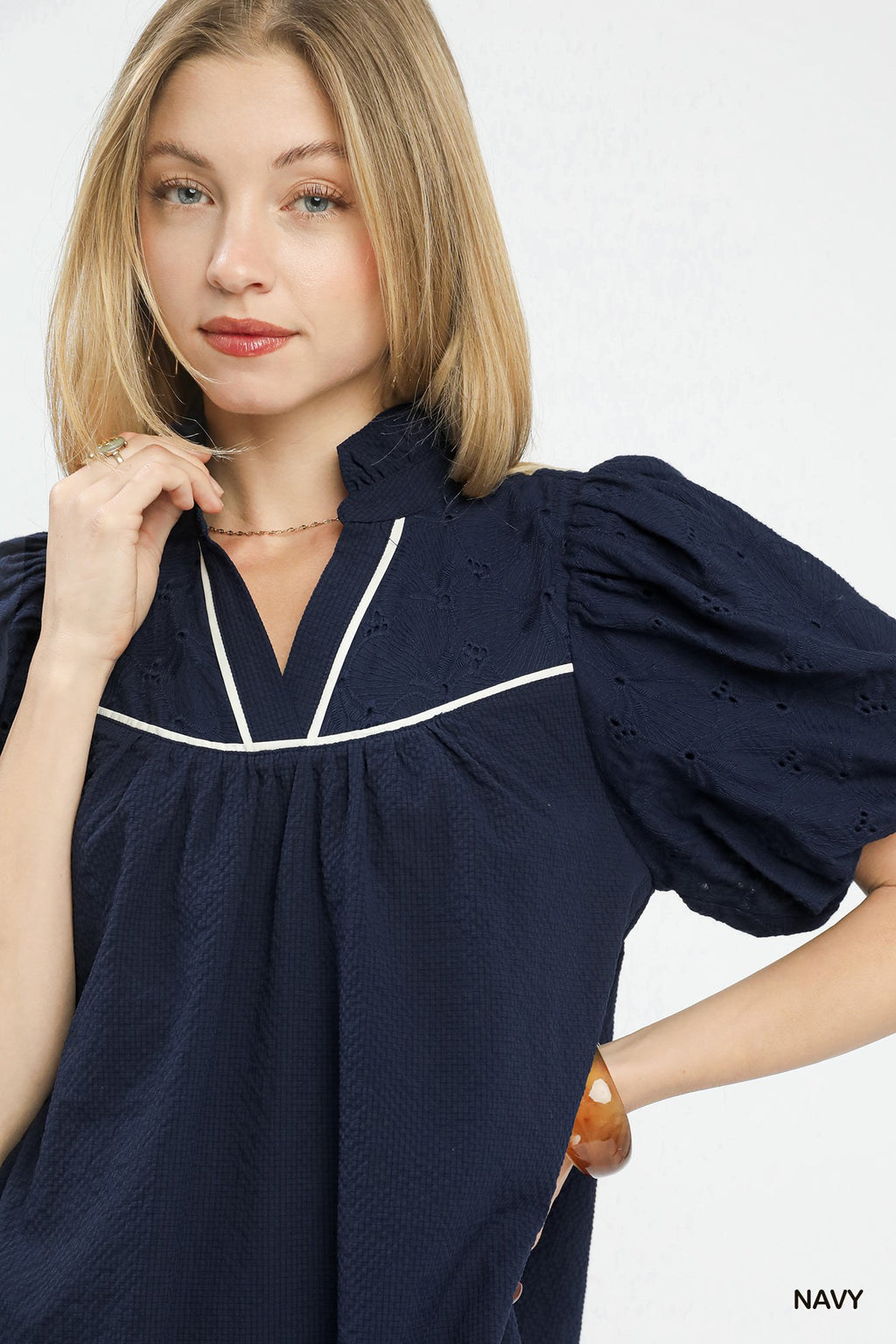 Textured puff sleeve babydoll dress by Umgee featuring a flowy silhouette and soft fabric, shown on a model.