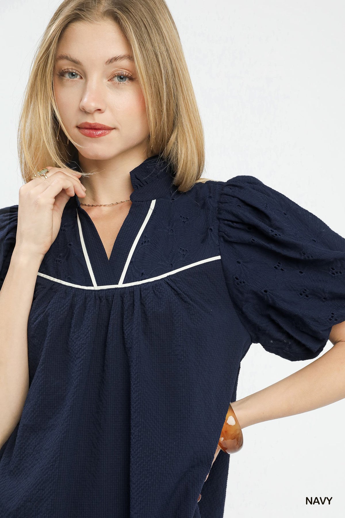 Textured puff sleeve babydoll dress by Umgee featuring a flowy silhouette and soft fabric, shown on a model.