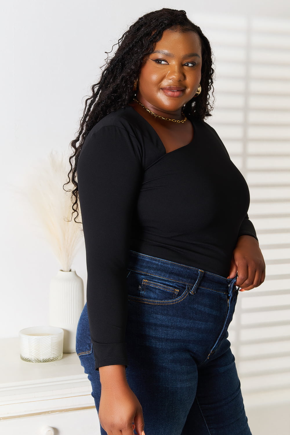 Black asymmetrical neck long sleeve top from Trendsi's Basic Bae collection, featuring a fitted design and stylish neckline.
