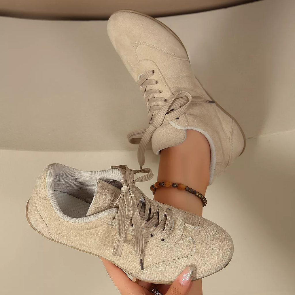 Round toe lace-up sneakers from Trendsi featuring a sleek design and comfortable fit, shown in a stylish side view.