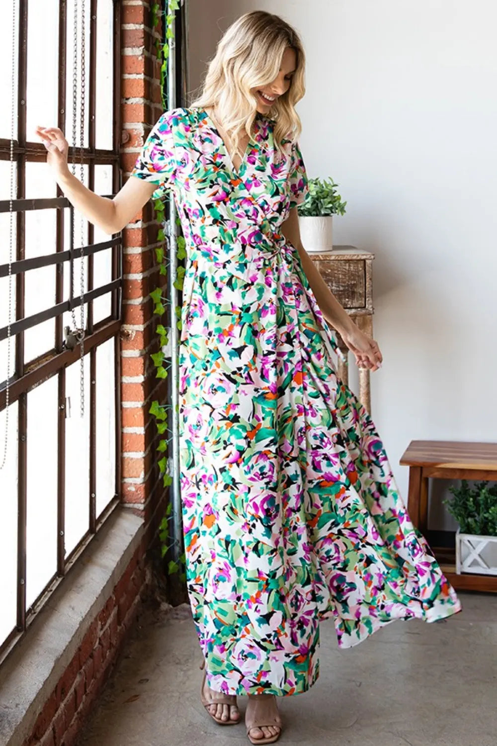 Printed First Love Slit Surplice Tie Waist Short Sleeve Dress by Trendsi, showing a stylish dress with a tie waist and slit detail.