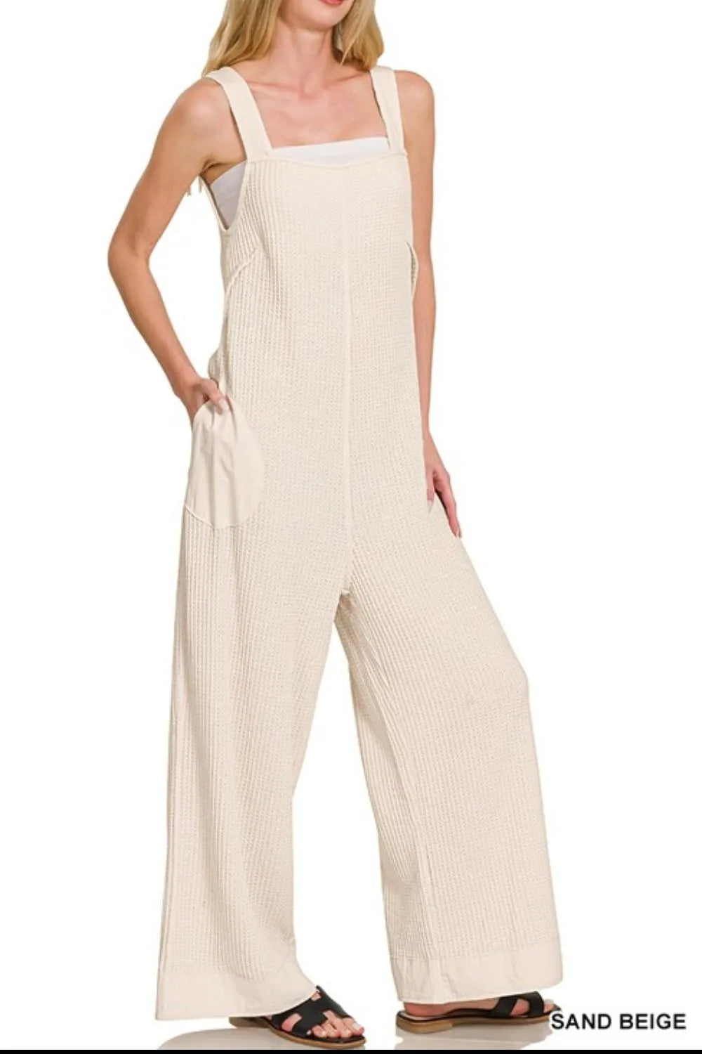 Zenana Knit Waffle Wide Leg Overalls in soft beige with a relaxed fit and adjustable shoulder straps, displayed on a hanger.