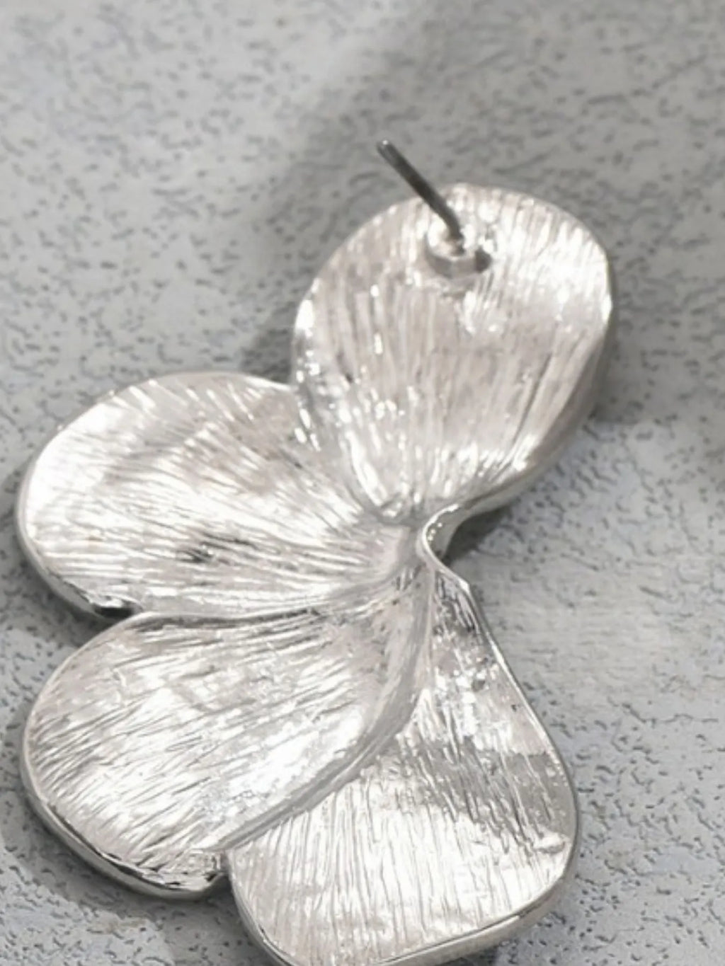 Stainless steel flower earrings with intricate petal design, featuring a shiny silver finish and delicate floral details.