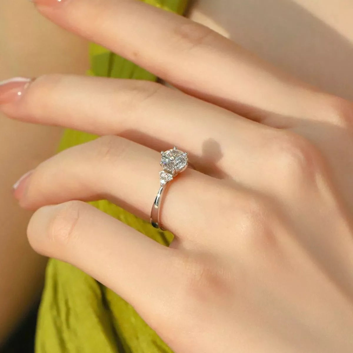 Sterling silver ring with 1 carat moissanite gemstone, elegant jewelry piece with a sparkling center stone.