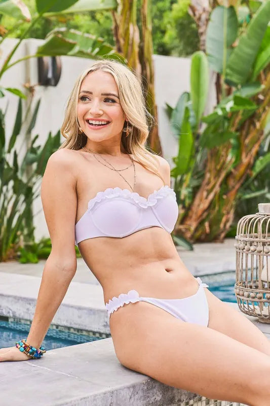 Trendsi And The Why frill trim bandeau bikini swim set with ruffled top and matching bottoms on a white background