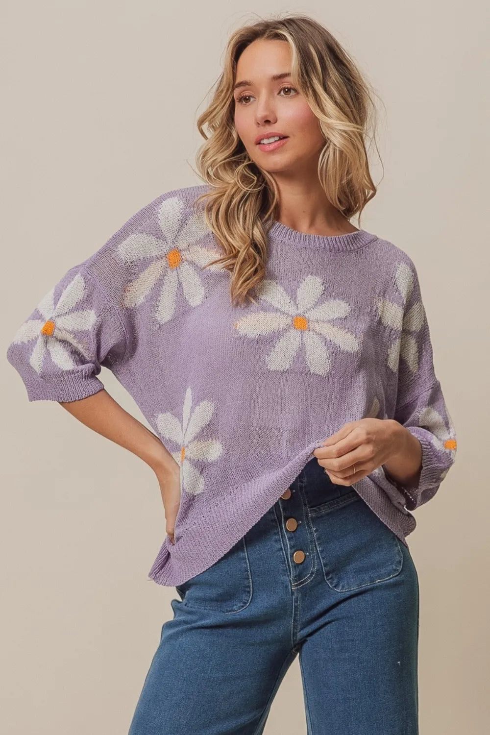 BiBi floral pattern slit sweater by Trendsi featuring a stylish floral design and a trendy slit detail on the sleeves.