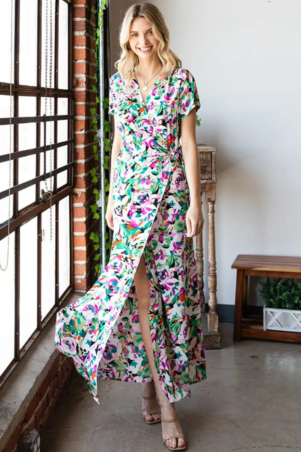 Printed white short sleeve dress with a surplice neckline, tie waist, and slit detail from Trendsi's First Love collection.