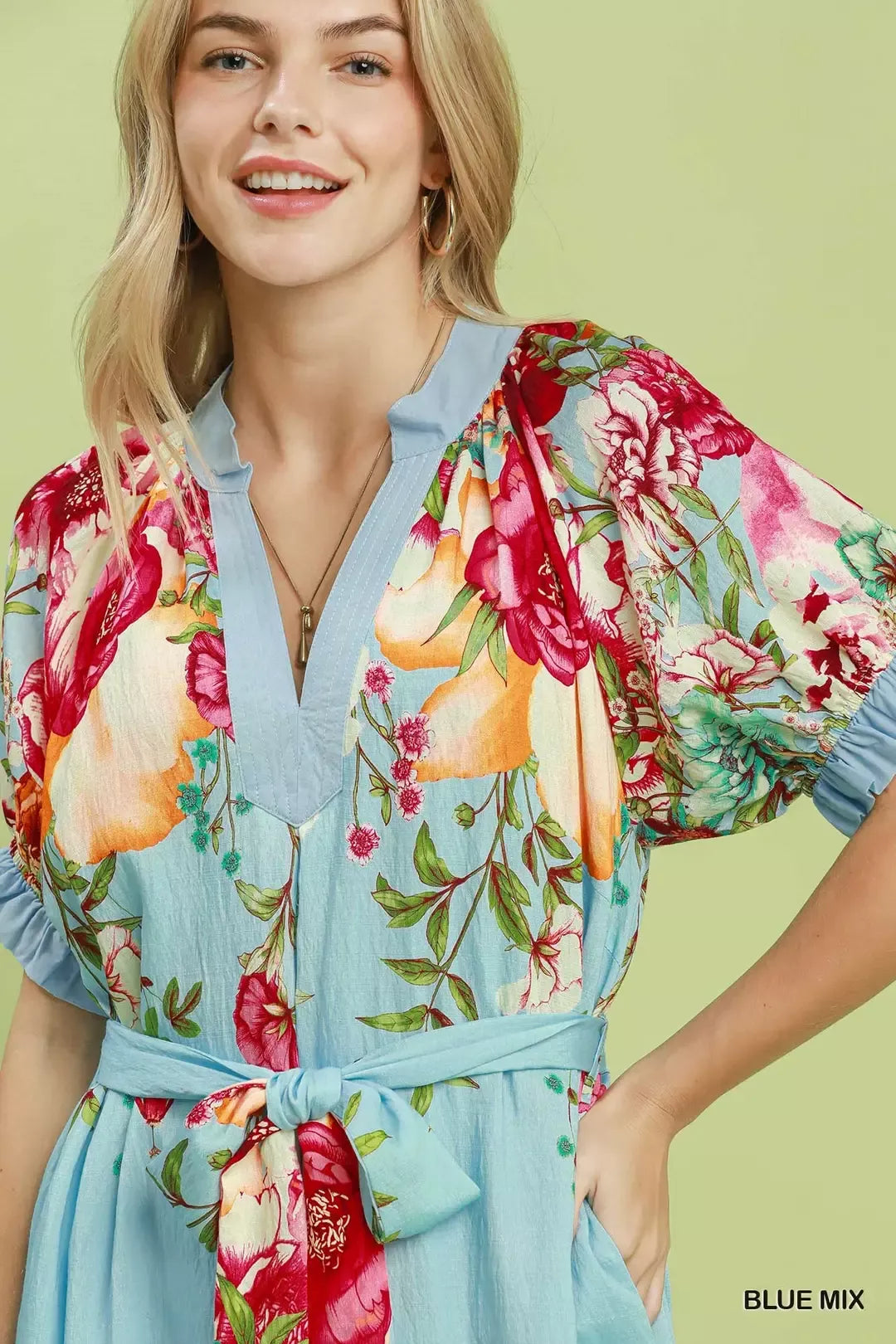 Umgee floral border print midi dress with a mix of colorful floral patterns and a flowy silhouette.