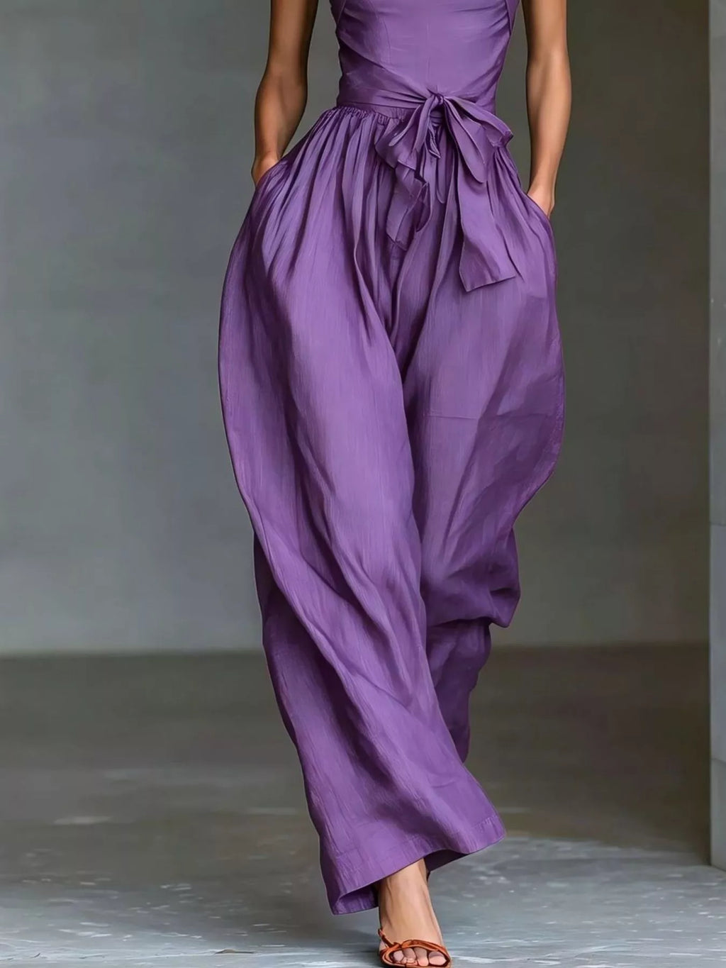 Halter neck wide-leg jumpsuit with waist-tie detail, stylish and comfortable, in a sleek design perfect for casual or semi-formal wear.