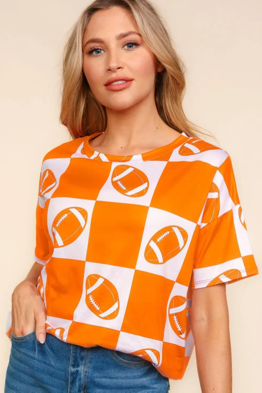 Haptics football checkered print short sleeve T-shirt by Trendsi featuring a bold checkered pattern and comfortable fit.