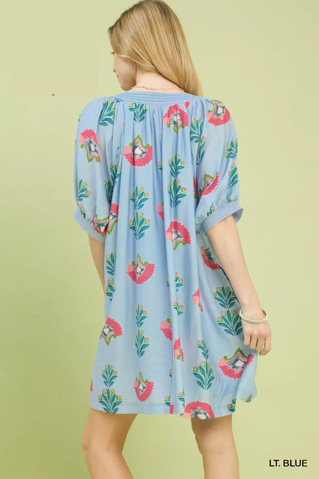 Umgee abstract print mini dress with vibrant colors and flowy fabric, styled for casual or summer wear.