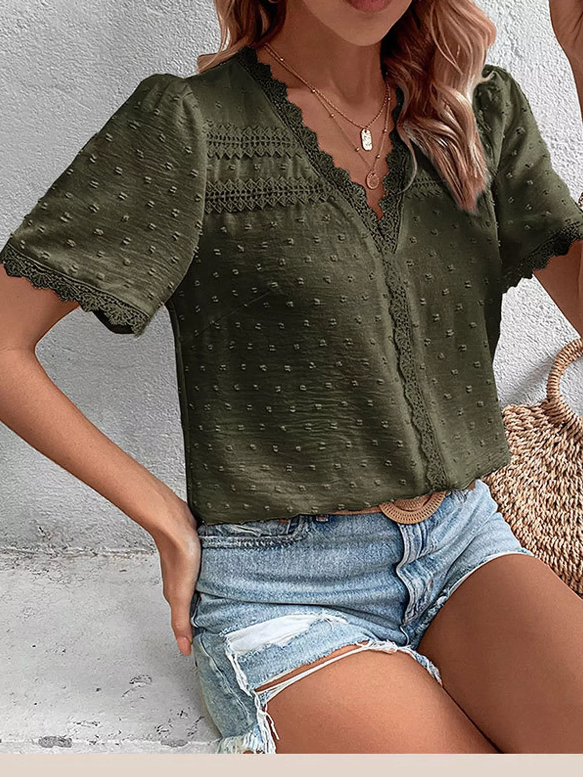Elegant Swiss Dot V-Neck blouse with lace trim from Trendsi, featuring a soft fabric and delicate detailing.