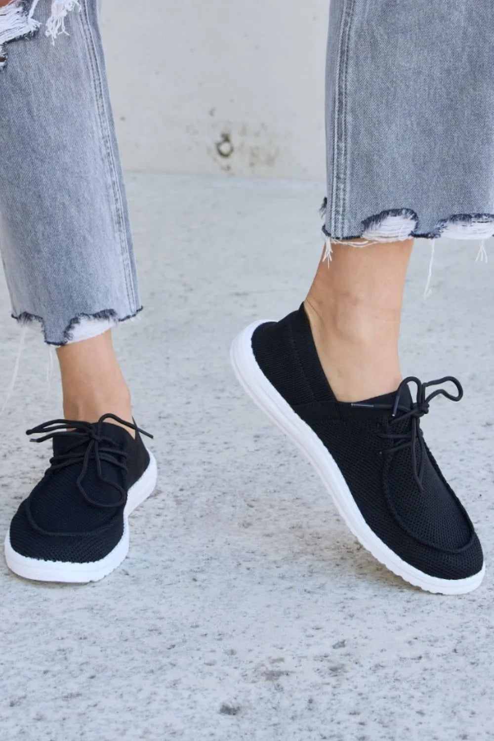 Forever Link flat round toe lace-up sneakers by Trendsi, featuring a sleek design and comfortable fit with white and black color options.