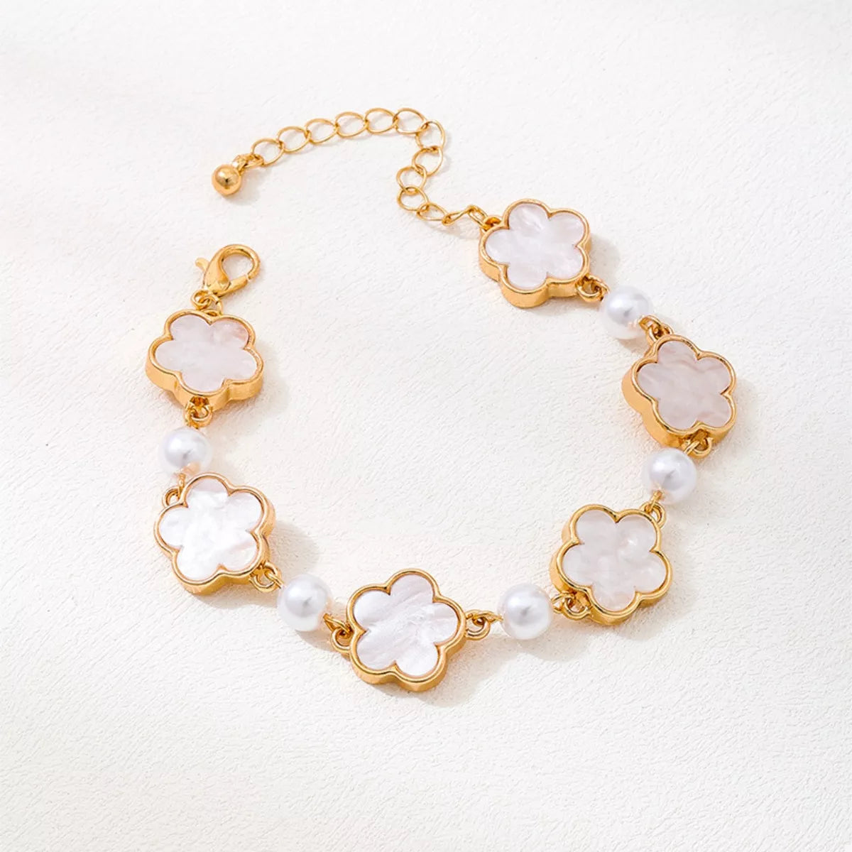 Gold-plated alloy flower bracelet with delicate floral design, perfect for elegant jewelry styling